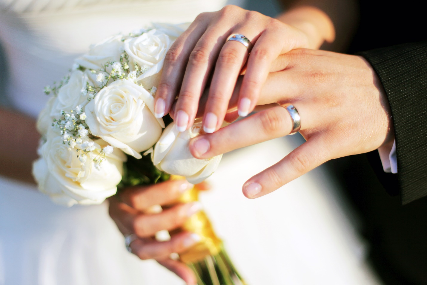 man and woman displaying wedding rings